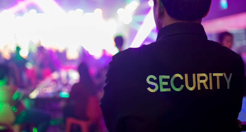 Image of a security guard wearing a jacket with 'security' on the back.